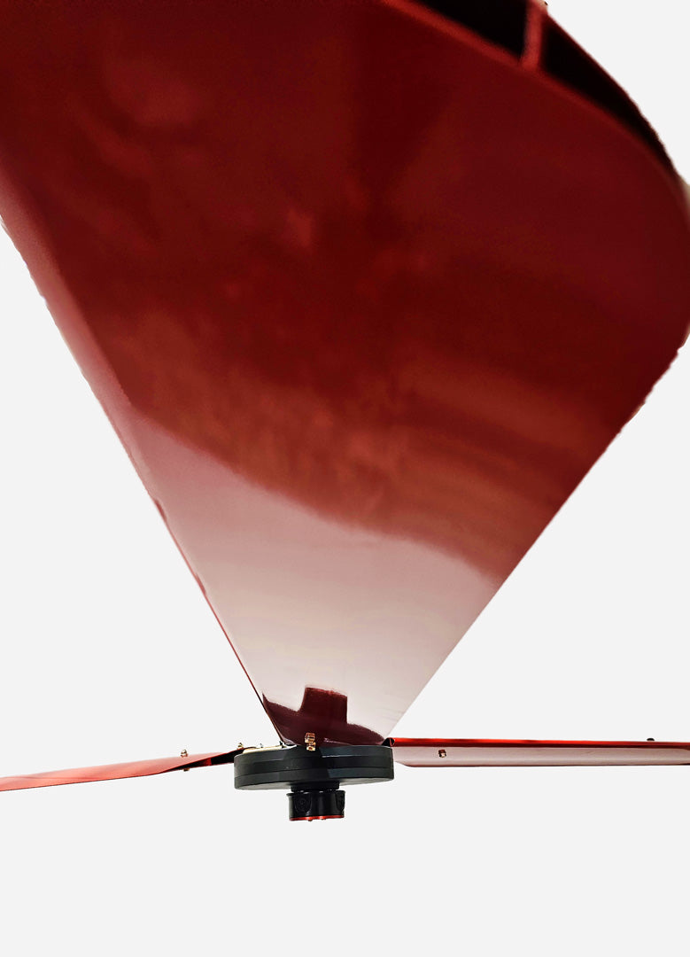 Close up of a one of the red blades, with motor and red brand badge in a distance,   for DF3 Red Industrial Ceiling Fan, product of Industrial Fan Co