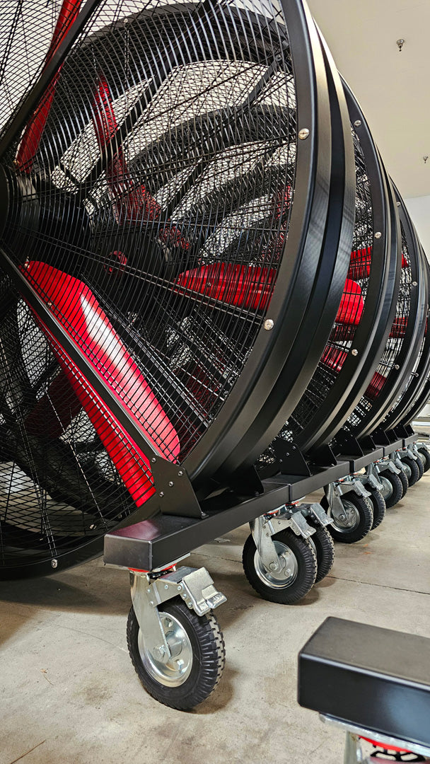 The raw of large industrial fans, WF72 Floor Fans, products of Industrial Fan Co, sitting on industrial floor