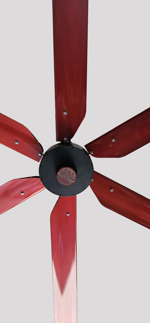 Close up of a motor casing, red and silver brand badge and 6 red blades with silver hardware for DF6 Red Industrial Ceiling Fan, product of Industrial Fan Co