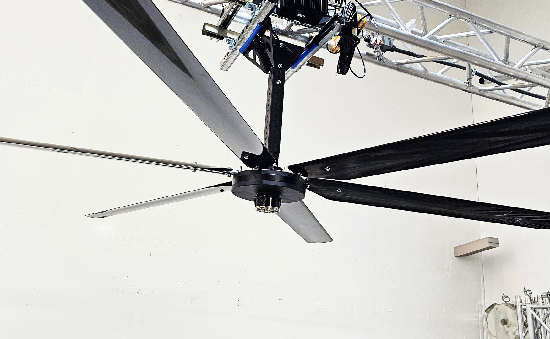 Close up of a telescoping mount, motor, silver brand badge and 6 blades for DF6 Black Industrial Ceiling Fan from Industrial Fan Co