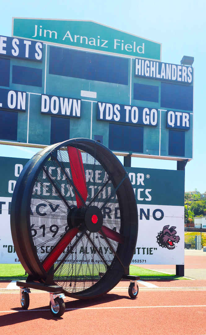 72" Floor Fan with black housing, red blades, metal frame, black and silver casters and metal bearings, product of Industrial Fan Co, on a track field of Jim Arnaiz Field