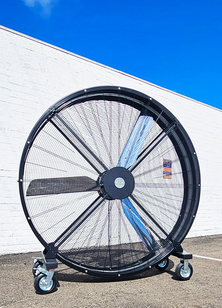 72" Floor Fan with black housing, polished aluminum silver blades, metal frame, black and silver casters and metal bearings, product of Industrial Fan Co, on a parking lot