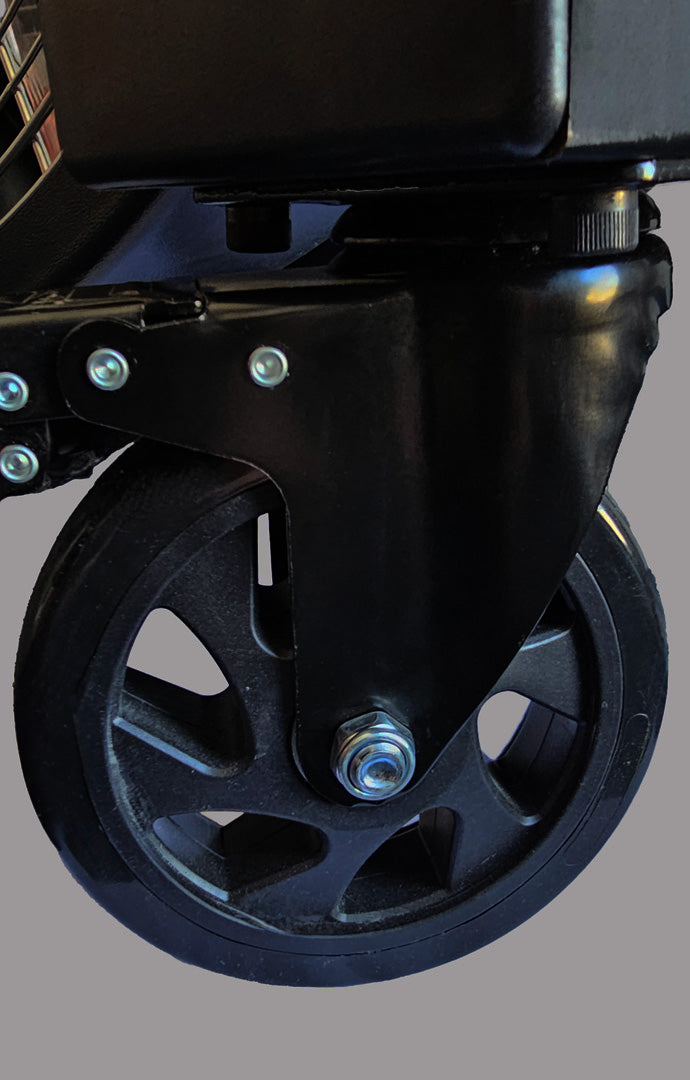 Close-up of a black wheel (caster) for 48" Floor Fan with metal bearings on a gray background, product of Industrial Fan Co