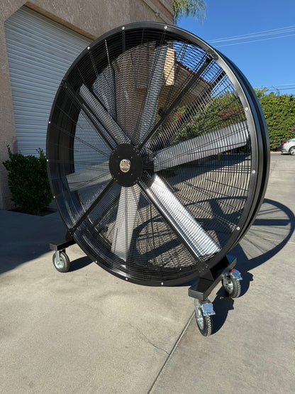 72" Floor Fan with black housing, polished aluminum silver blades, metal frame, black and silver casters and metal bearings, product of Industrial Fan Co, on a parking lot