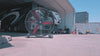 72" Floor Fan with black housing, red blades, metal frame, black and silver casters and metal bearings, product of Industrial Fan Co, in front of a hangar garage with a parked house on wheels