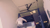 Man working on a red truck in a garage with a  DF3 Industrial Ceiling Fan above his head, product of Industrial Fan Co